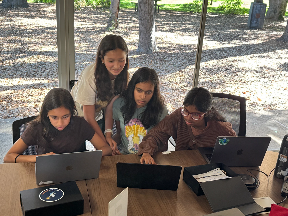 Students celebrating together at a youth startup demo day
